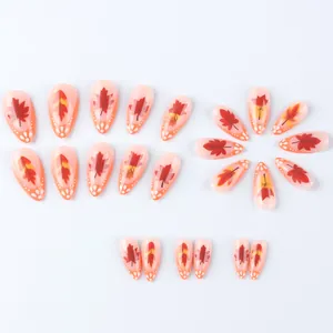 Detailed set of 24 almond-shaped press-on nails with autumn maple leaf and white polka dot patterns