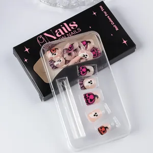 Detailed set of Halloween press-on nails featuring pumpkin, ghost and spider web designs