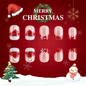 Macro detail of Christmas press-on nails featuring red and white snowflake patterns