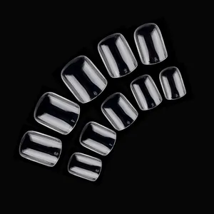 Macro view of transparent press-on nails set with numbered sizes from 0 to 9