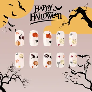 Detail of Halloween press-on nails featuring pumpkin, spider web, and star patterns