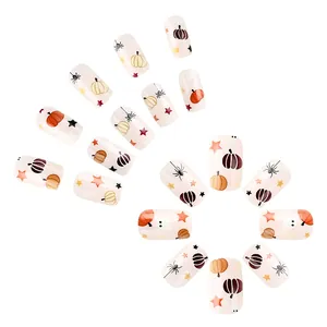Halloween press-on nails with pumpkin and spider patterns on cream base, 24 piece set