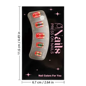 Detailed view of red Christmas press on nails with glitter and gold holiday patterns