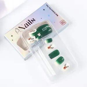 Detail of Christmas press-on nails set with green reindeer patterns and 24 pieces