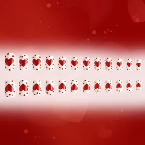 Short square press-on nails with red heart and polka dot design on white base