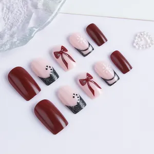 Christmas square fake nails with red bows, snowflakes, and glitter gradient design