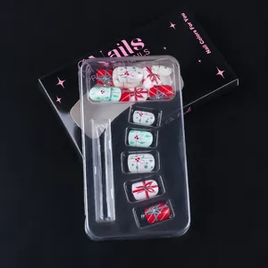 Detailed set of Christmas press-on nails with bow designs and festive berry patterns