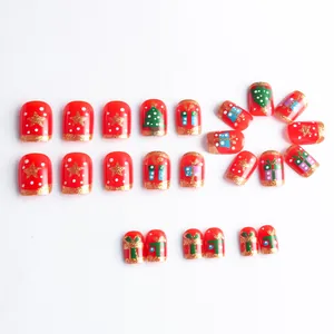 Short square Christmas press-on nails with red base, gold trees and glitter patterns