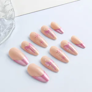 Pink almond press-on nails with french cat eye tips, bows and snowflake art