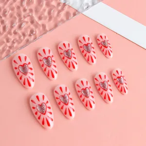 Almond shaped press-on nails with red heart patterns and silver glitter accents