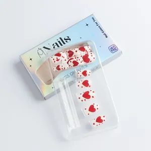 Detailed view of 24pcs Valentine's red heart press-on nails in iridescent blue packaging