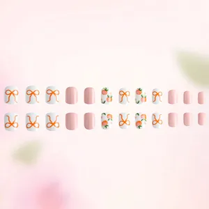 Short square press-on nails set with pink peach prints and orange bow designs, 24 pieces