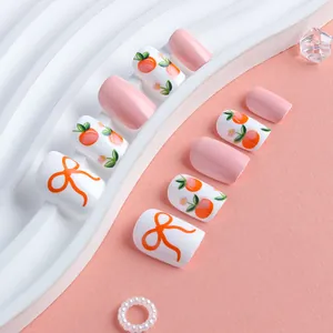 Sweet pink press-on nails with peach and floral patterns in short square shape