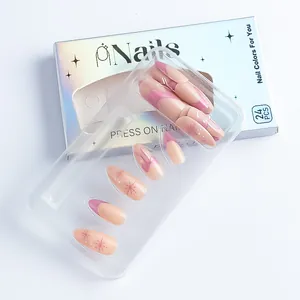Detail of pink French almond press-on nails with snowflake and bow patterns in box