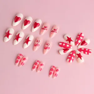 Pink almond press-on nails with heart, cherry, and star patterns for Valentine's Day