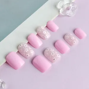 Short glossy square press-on nails featuring sweet pink flowers and white polka dots
