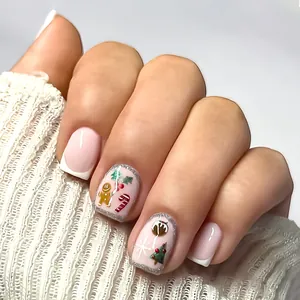 Cute pink Christmas press-on nails with cartoon gingerbread man and snowflake designs