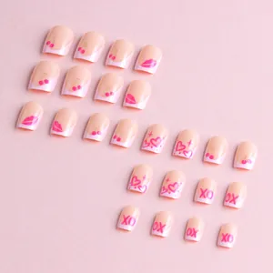 Pink press-on nail set featuring French tips with cherry, heart, and XO patterns
