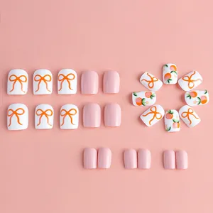 Short square press-on nails in pink with peach and bow designs, 24pcs manicure set
