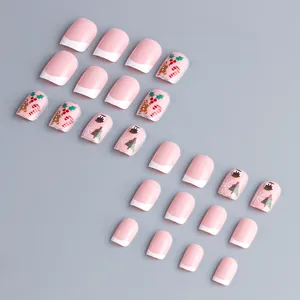Pink French Christmas press-on nails with cartoon gingerbread man and tree patterns