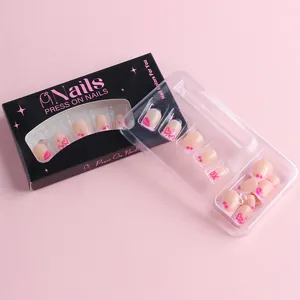 Pink press-on nails with sweet cherry and heart patterns in branded packaging