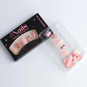 Christmas press-on nails set with pink French tips featuring gingerbread and tree motifs