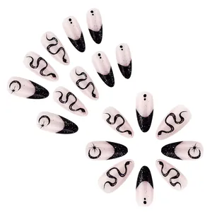 96pcs stiletto fake nails set with black snake and moon patterns on white background