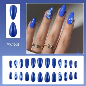 Short glossy blue press-on nails with white flower patterns and almond shape design