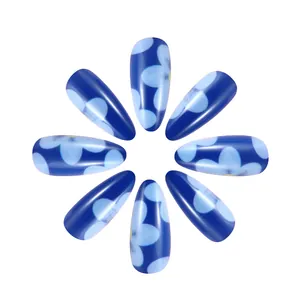 Detailed view of matte blue press-on nails with light blue flower patterns in a radial layout