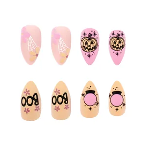 Detail of almond matte Halloween press-on nails with spider webs and boo graphics