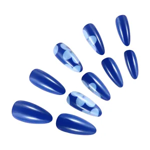 Detail of short glossy dark blue press-on nails with light blue floral patterns and almond shape