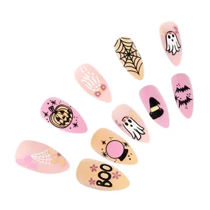 Detail of matte almond Halloween press-on nails with spider web and ghost patterns