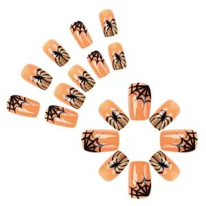Short orange and black Halloween press-on nails with spider web and gold glitter designs