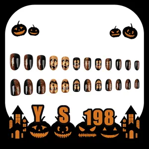 Short round Halloween press-on nails with black and orange glitter pumpkin face designs
