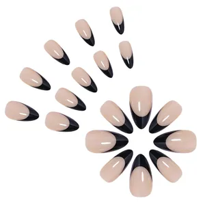 Macro detail of almond shaped French press-on nails in nude pink and black finish