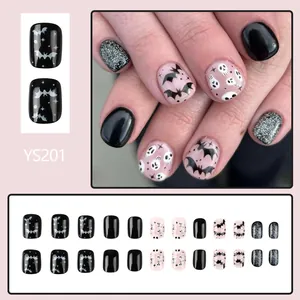 Short Halloween press-on nails with glossy bat and skull designs in black and pink