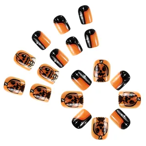 Short glossy Halloween press-on nails with Jack-o'-lantern orange smile and black star design