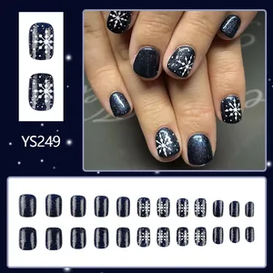 Short navy blue glitter press-on nails with white snowflakes for Christmas winter style