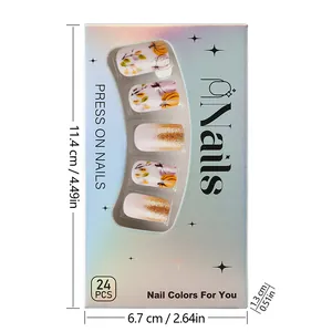 Detailed view of short pumpkin nails with glitter and size dimensions on package