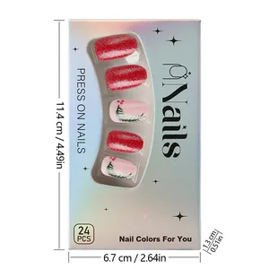 Macro view of Christmas nail tips set with red glitter and green leaf art in silver box