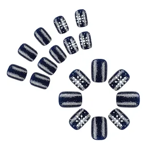 Short square navy blue press-on nails with white snowflake and silver glitter details