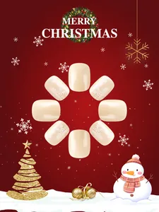 Close-up of cream short press-on nails with white snowflake and glitter Christmas art
