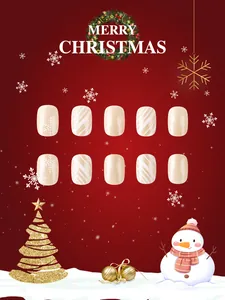Close-up of beige Christmas fake nails featuring white snowflakes and stripe patterns