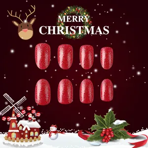 Short red glitter Christmas press-on nails with festive reindeer and snowflake patterns