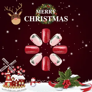 Detail of Christmas nail press-ons featuring red glitter and pine branch nail art