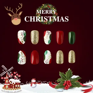 Detail view of festive Christmas press-on nails with red berry and gold leaf patterns