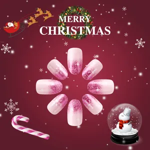 Short oval Christmas press-on nails with pink glitter gradient and white snowflake patterns