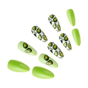 Close-up of avocado themed green almond press-on nails with glossy fruit print finish