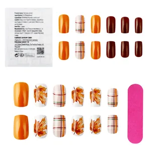 Short square press-on nails featuring autumn maple leaf patterns and plaid color block designs