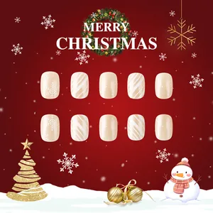 Christmas theme press-on nails with white snowflakes and stripes on champagne base